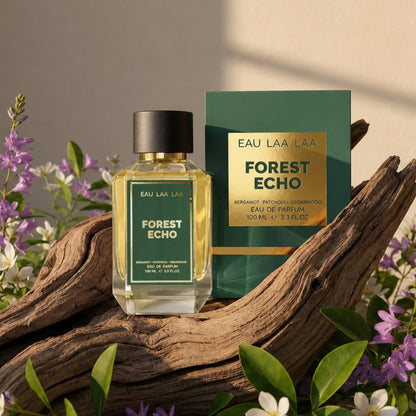 Eau Laa Laa Forest Echo perfume bottle and packaging on a wooden log with flowers.