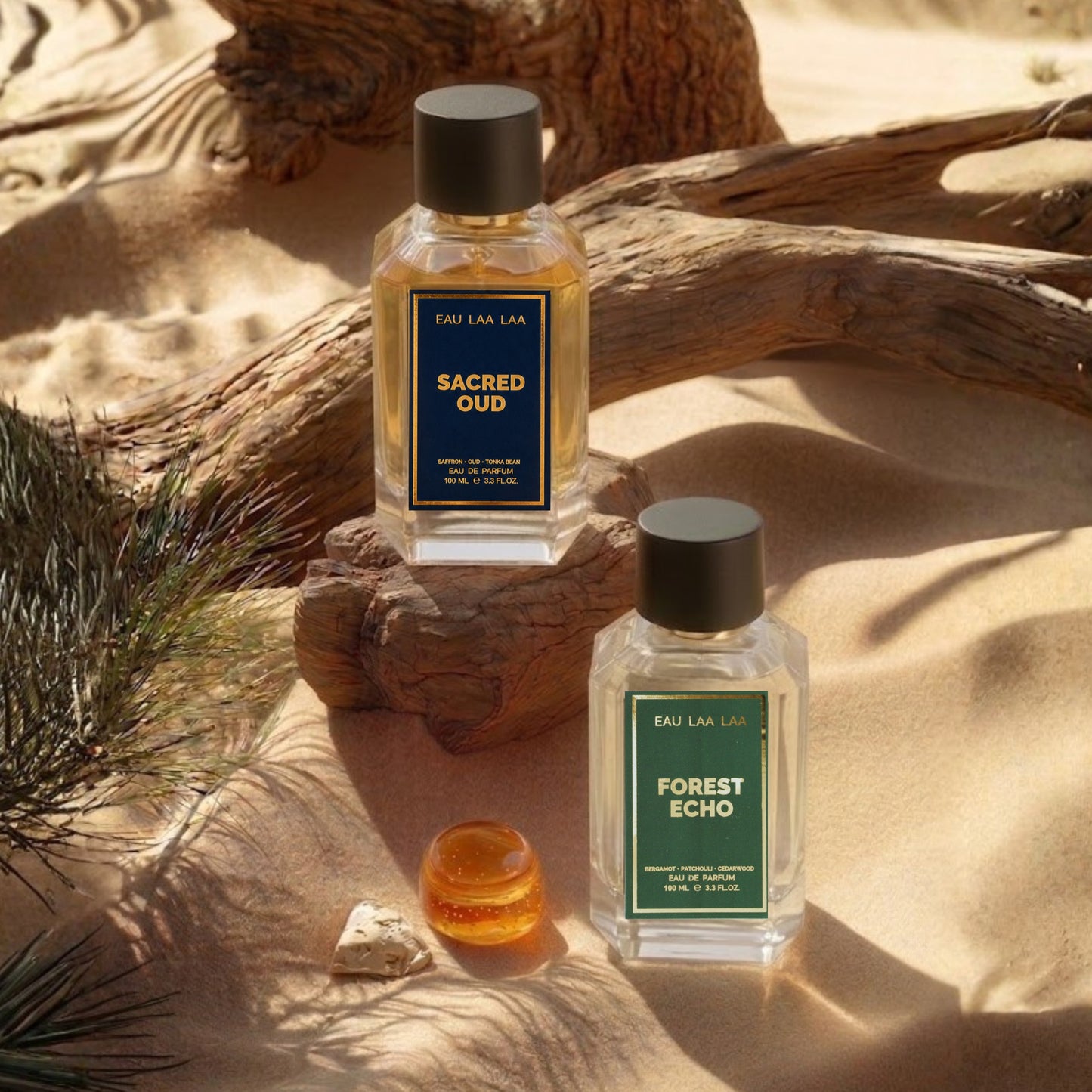 Two perfume bottles labeled 'Sacred Oud' and 'Forest Echo' on a sandy surface with natural elements.